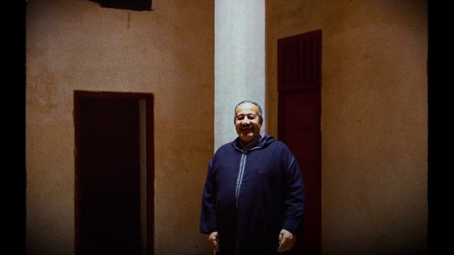 Video Reference: Smile, Human, Sleeve, Flash photography, Wood, Door, Jacket, Eyewear, Event, Darkness