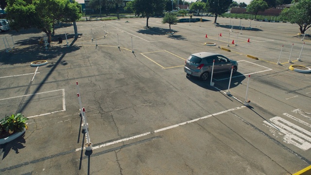 Video Reference: Car, Vehicle, Tire, Road surface, Wheel, Asphalt, Land lot, Tree, Urban design, Thoroughfare