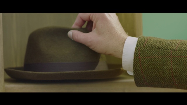 Video Reference: Fedora, Neck, Hat, Sleeve, Comfort, Gesture, Headgear, Finger, Costume hat, Sun hat