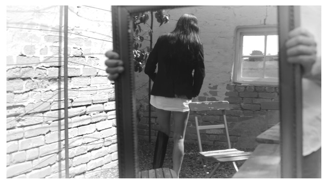 Video Reference: Black, Standing, Black-and-white, Gesture, Style, Window, Tints and shades, Monochrome photography, Monochrome, Waist