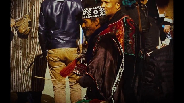 Video Reference: Human, Hat, Fashion design, Street fashion, Event, Uniform, Tradition, Tribe, Necklace, Eyewear