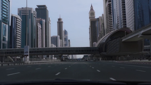 Video Reference: Sky, Building, Skyscraper, Daytime, Mode of transport, Tower, Tower block, Road surface, Cityscape, Asphalt