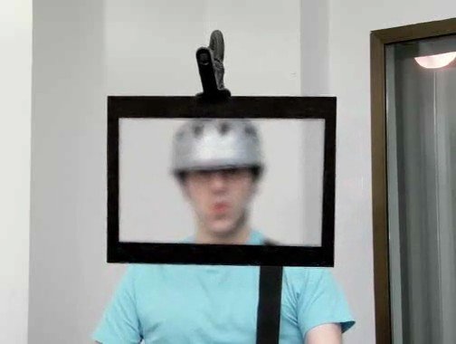 Video Reference: person, helmet, blurred, frame, indoor, portrait, masking, window, wall, standing, abstract, unfocused