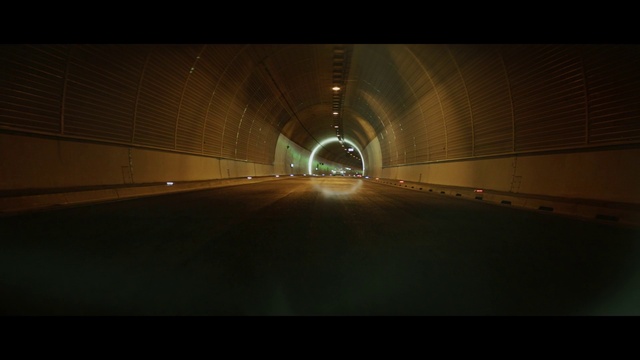Video Reference: Automotive lighting, Electricity, Road surface, Asphalt, Tunnel, Tints and shades, Road, Symmetry, Headlamp, Space