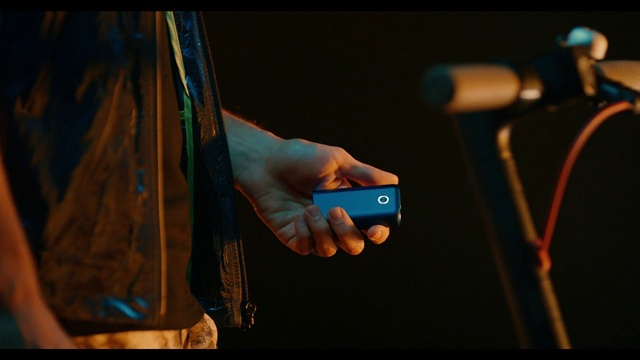 Video Reference: Hand, Sleeve, Gesture, Microphone, Wrist, Gadget, Nail, Electric blue, Thumb, Recreation