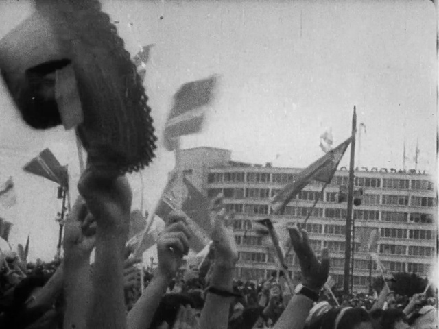 Video Reference: Photograph, White, Building, Black-and-white, Gesture, Style, Crowd, Fan, Monochrome, Flag