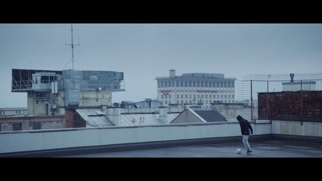 Video Reference: Sky, Building, Urban design, Tints and shades, City, Rectangle, Window, Roof, Facade, Asphalt