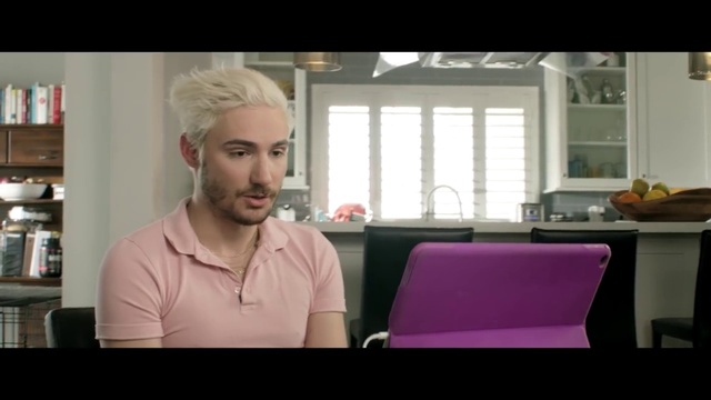 Video Reference: Window, Jaw, Neck, Beard, Eyewear, Facial hair, Magenta, Chair, T-shirt, Sitting