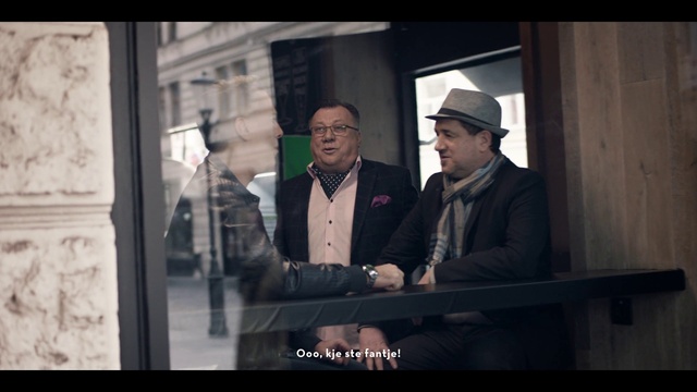 Video Reference: Hat, Fedora, Flash photography, Standing, Gesture, Sun hat, Blazer, Eyewear, Formal wear, Suit