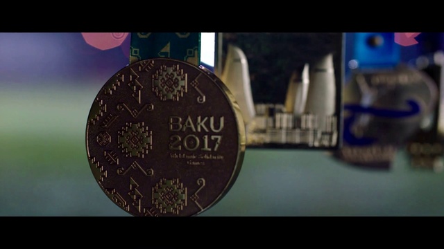 Video Reference: Font, Circle, Nickel, Electric blue, Metal, Fashion accessory, Engineering, Macro photography, Coin, Logo