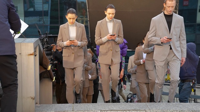 Video Reference: Suit trousers, Coat, Standing, Khaki pants, Suit, Entertainment, Fashion design, Blazer, White-collar worker, Event