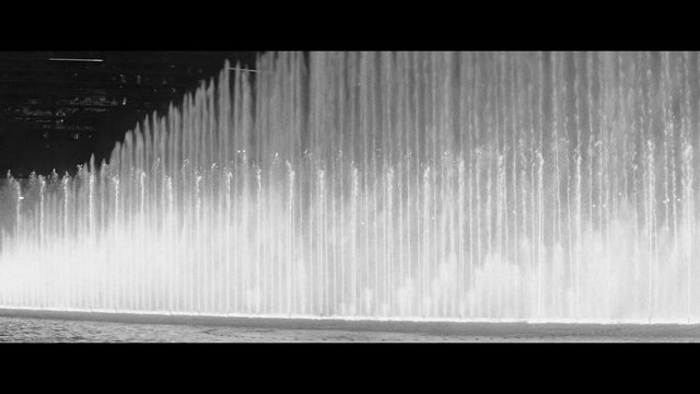 Video Reference: fountain, water jets, night, black and white, water spray, landscape, urban, nightscape, decorative fountain, wide shot, water feature