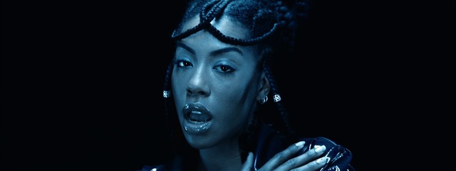 Video Reference: Lip, Eyebrow, Eyelash, Human, Fashion, Flash photography, Ear, Jaw, Purple, Audio equipment