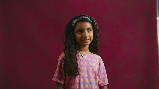 Video Reference: Lip, Smile, Flash photography, Purple, Sleeve, Happy, Black hair, Fashion design, Magenta, Cornrows