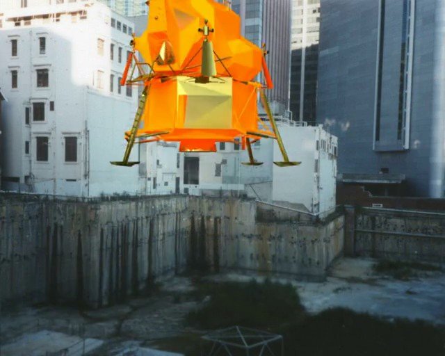 Video Reference: lunar lander, spacecraft, model, suspended, construction site, excavation, urban, buildings, orange, engineering, simulation, mockup