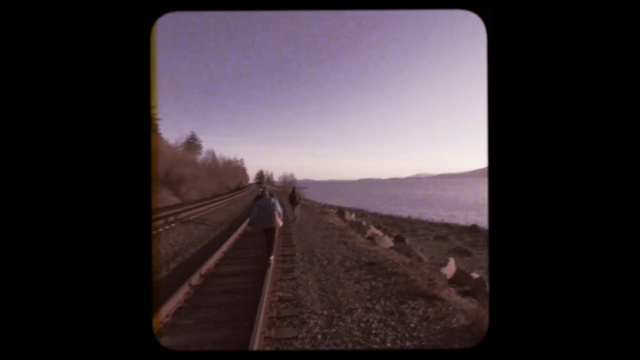 Video Reference: Sky, Train, Atmospheric phenomenon, Horizon, Picture frame, Travel, Landscape, Tints and shades, Track, Auto part