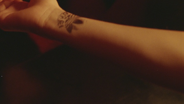 Video Reference: Gesture, Sleeve, Finger, Elbow, Temporary tattoo, Wrist, Font, Human leg, Nail, Tattoo