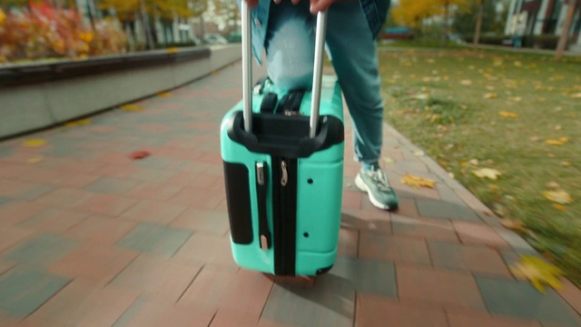 Video Reference: Green, Flooring, Floor, Rolling, Asphalt, Luggage and bags, Street fashion, Bag, Bumper, Cleanliness