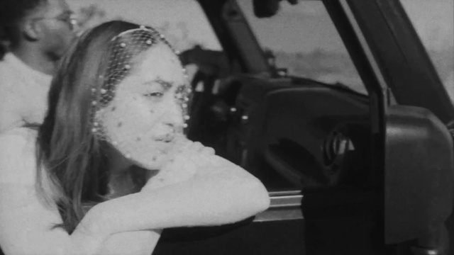 Video Reference: Black, Vehicle, Motor vehicle, Flash photography, Automotive mirror, Car, Gesture, Black-and-white, Style, Automotive design