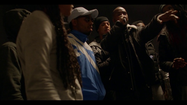 Video Reference: Hat, Cap, Flash photography, Baseball cap, Microphone, Entertainment, Event, Sun hat, Darkness, Crowd