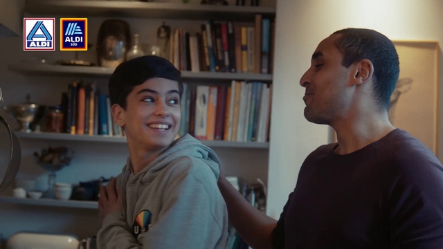 Video Reference: Clothing, Forehead, Head, Smile, Shirt, Bookcase, Shelf, Mouth, Organ, Ear