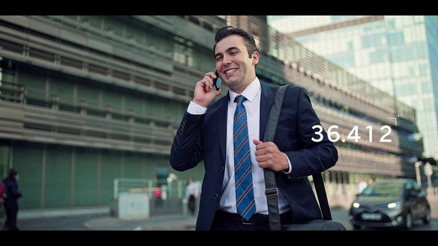Video Reference: Microphone, Smile, Human, Coat, Tie, Flash photography, Standing, Gesture, Street fashion, Spokesperson