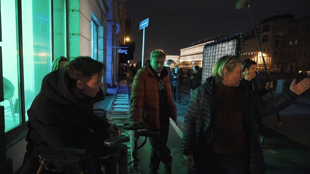 Video Reference: Standing, Building, Jacket, Chair, City, Road, Midnight, Event, Urban area, Darkness