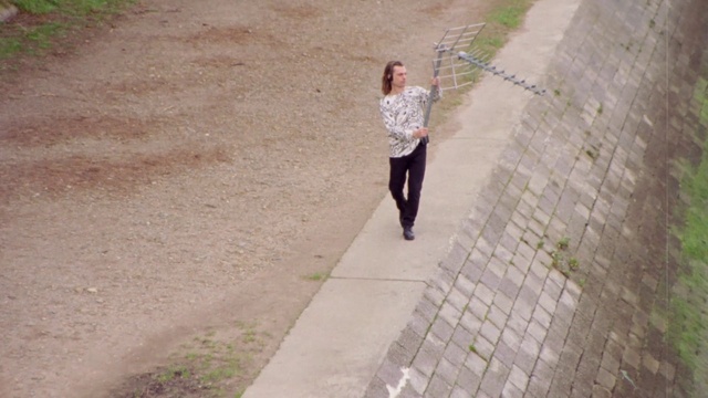 Video Reference: Road surface, Asphalt, Sidewalk, Grass, Recreation, Leisure, Road, People in nature, Street fashion, Landscape