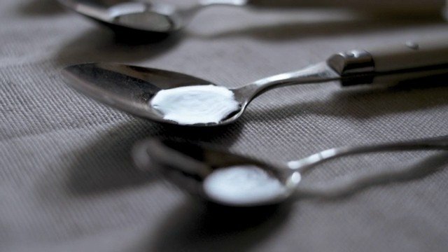 Video Reference: spoons, metal, cream, white substance, tabletop, close-up, shallow depth of field, textured surface, arrangement, kitchenware, macro, soft focus