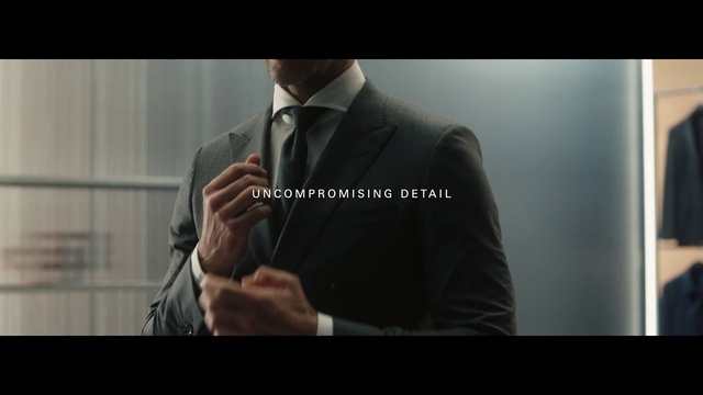 Video Reference: Outerwear, Arm, Tie, Dress shirt, Coat, Sleeve, Flash photography, Microphone, Gesture, Collar