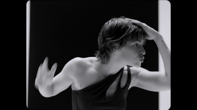 Video Reference: Arm, Shoulder, Human body, Flash photography, Neck, Window, Gesture, Elbow, Style, Black-and-white