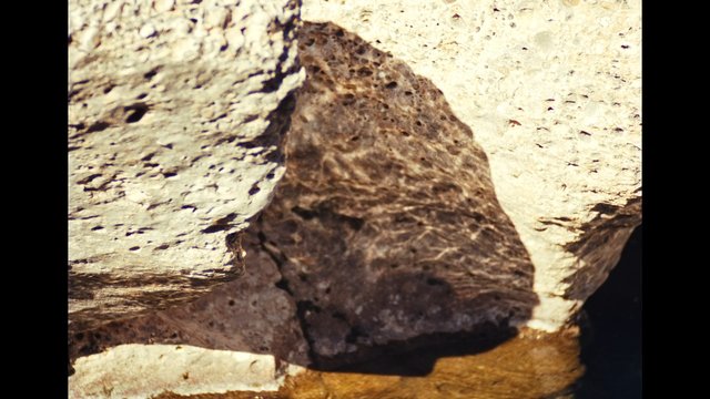 Video Reference: rock, stone, cliff, texture, close-up, nature, geology, surface, shadow, water, outdoor, abstract, background