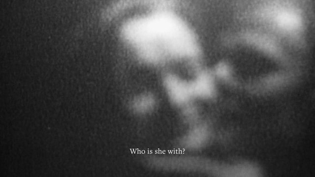 Video Reference: blurry, grayscale, close-up, face, indistinct, subtitle, text, dark, low-light, abstract, out-of-focus, monochrome