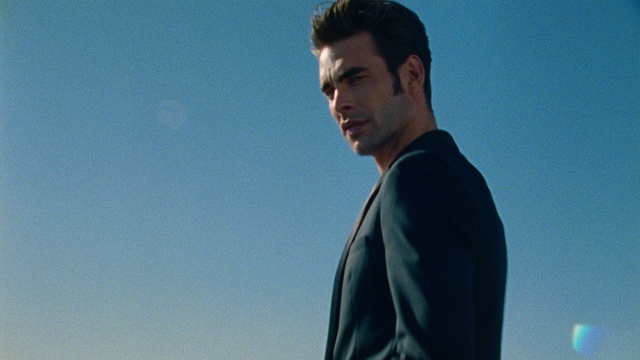 Video Reference: Sky, Azure, Flash photography, Neck, Sleeve, Gesture, Dress shirt, Blazer, Formal wear, Electric blue