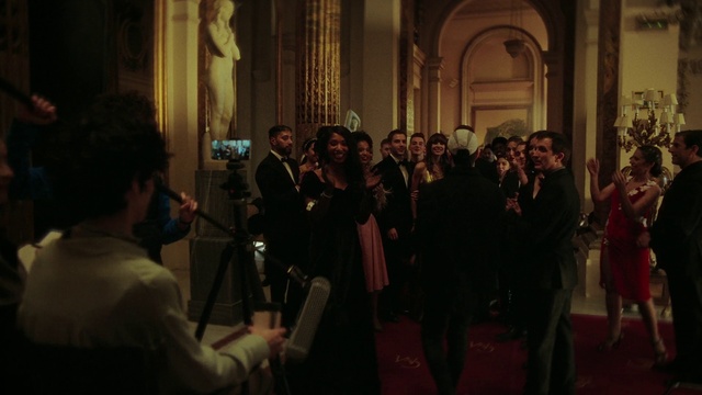 Video Reference: Coat, Entertainment, Suit, Music, Formal wear, Event, Crowd, Musician, Chair, Flooring