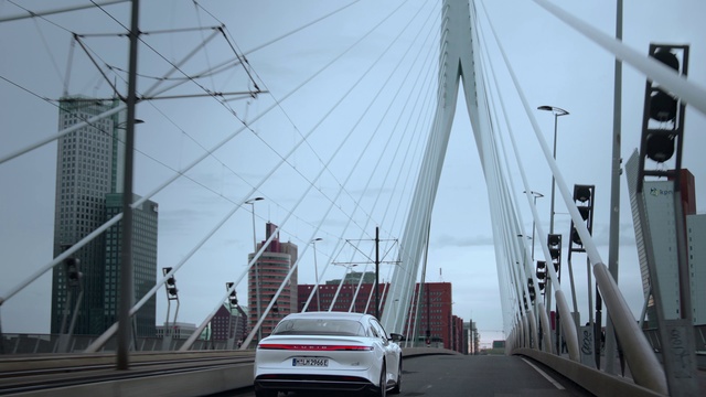 Video Reference: Sky, Vehicle, Car, Automotive lighting, Infrastructure, Automotive design, Electricity, Line, Motor vehicle, Skyscraper