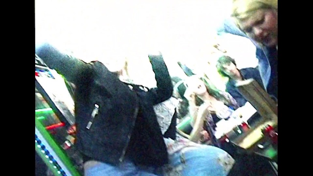 Video Reference: Gesture, Art, Event, Hat, Visual arts, Font, Fun, Display device, Chair, Sitting