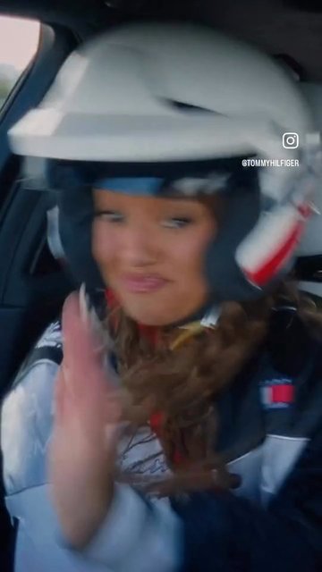 Video Reference: racing, helmet, driver, car interior, motorsport, close-up, blurred, action, female-presenting, sportswear, candid, in-car, watermark