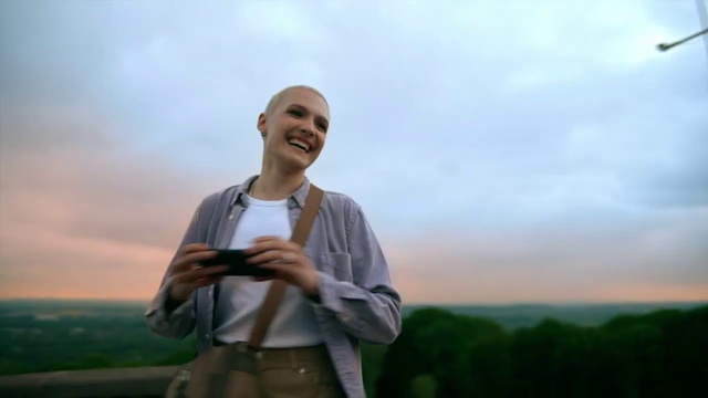 Video Reference: Cloud, Sky, Smile, Flash photography, Sleeve, Standing, Happy, Gesture, Travel, Grassland