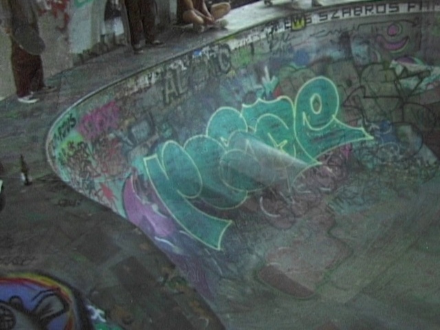 Video Reference: Green, Organism, Art, Graffiti, Font, Asphalt, Event, Visual arts, City, Concrete
