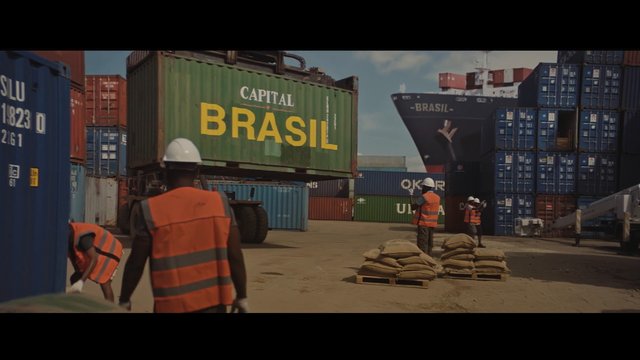 Video Reference: container yard, port, shipping containers, dockworkers, hard hats, safety vests, cargo ship, heavy machinery, logistics, industrial, freight, warehouse, stacked containers, lifting, worksite