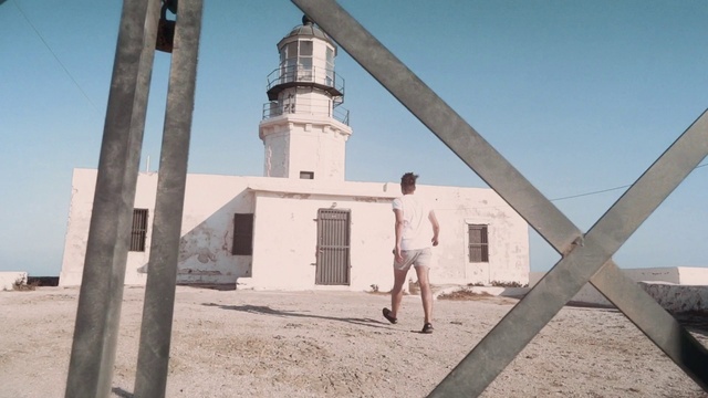 Video Reference: Lighthouse, Sky, Shorts, Building, Tower, Window, Body of water, House, Bermuda shorts, Tree