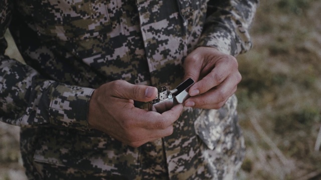 Video Reference: Hand, Sleeve, Gesture, Finger, Military camouflage, Nail, Wood, Plant, Thumb, Wrist