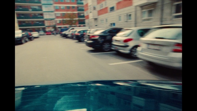 Video Reference: Car, Vehicle, Motor vehicle, Automotive lighting, Automotive tail & brake light, Blue, Building, Infrastructure, Road surface, Window