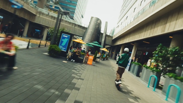 Video Reference: Building, Plant, Road surface, Urban design, Sidewalk, Road, City, Leisure, Metropolitan area, Travel