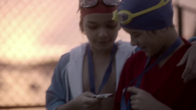 Video Reference: Hand, Cap, Gesture, Goggles, Headgear, Eyewear, Smile, Event, Happy, Electric blue