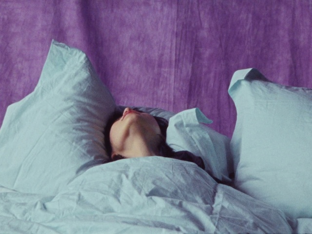 Video Reference: Hair, Head, Eye, Furniture, Comfort, Leg, Purple, Human body, Dress, Textile