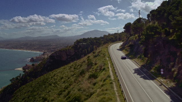 Video Reference: Cloud, Sky, Plant, Ecoregion, Mountain, Highland, Road surface, Asphalt, Slope, Terrain