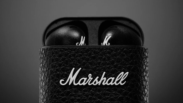 Video Reference: wireless earbuds, earbuds case, black, charging case, close-up, product shot, audio, headphones, portable, minimal background, tech, accessory