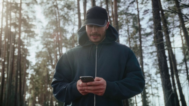 Video Reference: Hand, Cap, Natural environment, Tree, Sleeve, Wood, Jacket, Beard, Recreation, Sky